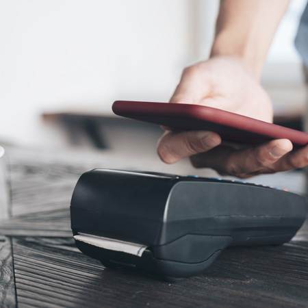 スマホで決済する男性の画像